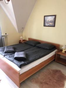 a bedroom with a large bed with black pillows at U Biela in Poronin