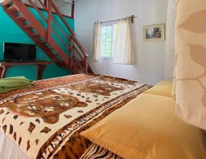 a bedroom with a bed with a leopard blanket at Rainforest Yasmin Hotel in Santa Fe