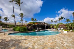 a resort pool with a slide and a waterfall at Kauai Beach Resort Room 2401 in Lihue