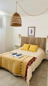 a bedroom with a large bed with yellow pillows at Espacio Edison 1 in Santa Rosa