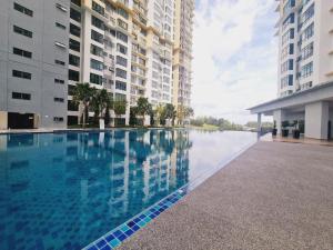 a swimming pool in front of two tall buildings at New! 4-7pax 2bedrooms condo near Mount Austin JB in Johor Bahru