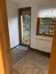 an empty room with a door and a window at Sulaba in Weilheim an der Teck