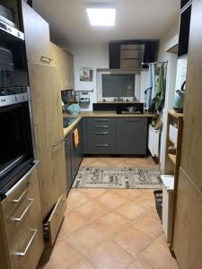 a kitchen with gray cabinets and a tiled floor at Sulaba in Weilheim an der Teck