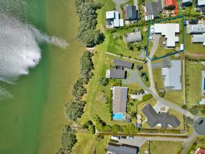 an aerial view of a house next to the water at Estuary Bliss Getaway in Mangawhai