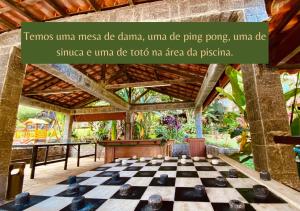 a chess board in a room with a wooden ceiling at Hotel da Cachoeira in Penedo