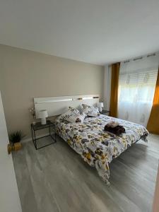a bedroom with a bed with a cat laying on it at La Casa M'SOL in Sant Feliu de Guixols
