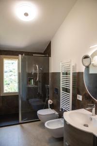 een badkamer met 2 wastafels, een toilet en een douche bij Villa Dune di Scivu in Portixeddu