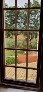 a window with a view of a wooden deck at Casa in Provinca in Orbetello +12 photos