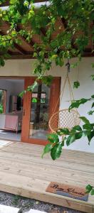 a porch with a swing hanging from a building at Casa Flor de Dendê, Serra Grande, Bahia in Serra Grande