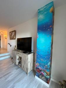 a living room with a wall with an aquarium at La Casa M'SOL in Sant Feliu de Guixols