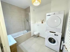a white bathroom with a washing machine in it at Bohemian Lodge Near Paris 8P Metro 14 in Saint-Ouen