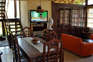 a living room with a dining room table and a television at Casa Rio das Ostras in Rio das Ostras