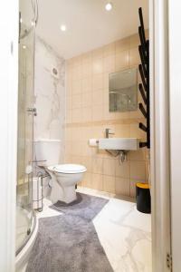 a bathroom with a toilet and a sink at Charming One-bed Flat in Dagenham