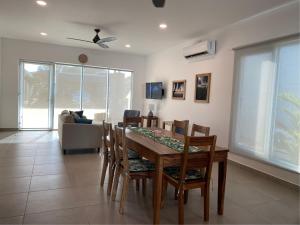 a dining room with a table and chairs and a couch at Casa Gravel in Pochote