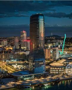 a tall building in a city at night at Galerija Libera in Belgrade