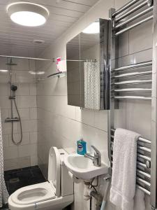 a small bathroom with a toilet and a sink at One small bed apartment by monishortlets in Dagenham
