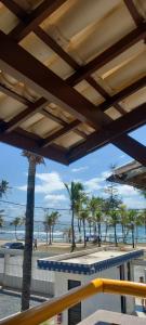 a view of a beach with palm trees and the ocean at Casa di lana in Salvador