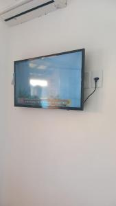 a flat screen tv hanging on a wall at Casa di lana in Salvador