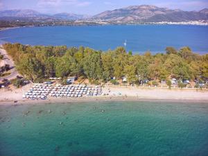 an aerial view of a beach with people in the water at Camping Drepanos in Igoumenitsa