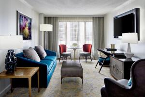 a living room with a blue couch and a table at Grand Bohemian Hotel Orlando, Autograph Collection in Orlando