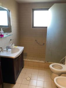 a bathroom with a sink and a toilet at one bedroom apartments aqaba on 2 swimming pool Tala bay in Aqaba