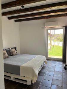 a bedroom with a bed and a large window at Nature&Soul - Sol in Vila do Bispo