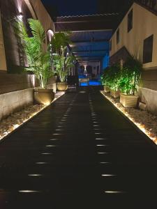 a walkway with plants in a building at night at Royal LUXURY Villa with Private Heated Pool Sheikh Zayed City Cairo اجمد ڤيلا بجد في الشيخ زايد حمام سباحة خاص ساخن درجة حراره 40 in 6th Of October +30 photos