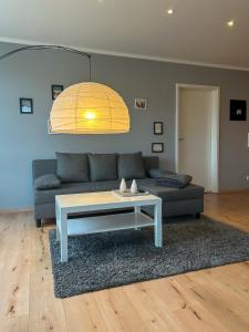 a living room with a couch and a coffee table at FeWo L19 One - Nespresso, Parkplatz in Bamberg