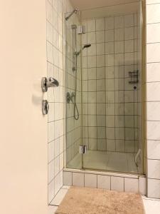 a shower with a glass door in a bathroom at FeWo L19 One - Nespresso, Parkplatz in Bamberg