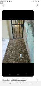 una foto de una puerta con una taza en el suelo en July, en San Felipe de Puerto Plata