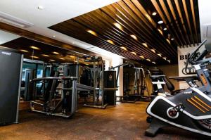 a gym with several tread machines in a room at Primahem Group in Accra
