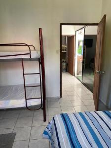 a bedroom with a bunk bed and a mirror at Beach Lomas in La Libertad