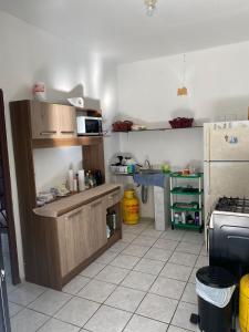 a kitchen with a counter and a refrigerator and a sink at Beach Lomas in La Libertad