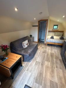 a living room with a bed and a couch at Morvan Pod & Hot tub in Fort William