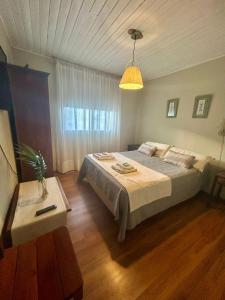 a bedroom with a large bed and a table at La maison in Caviahue
