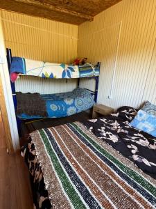 a bedroom with two beds in a room at Los avellanos in Chonchi