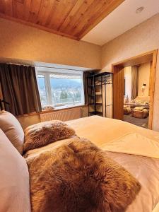 a bedroom with a large bed with furry pillows on it at ALPINA NEW apartment in the mountains in Špindlerův Mlýn