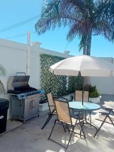 a patio with a grill and a table and chairs at Puerto San Carlos Bay House & Tours -1st Floor- in San Carlos