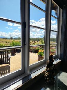 a window with a view of a wooden deck at The Old Dairy on Winkleigh in Exeter