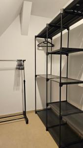 a black shelving unit in a room with a basketball hoop at FeWo AS 5 One Bamberg in Hallstadt