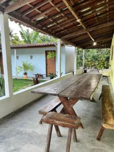 una mesa de picnic de madera y sillas en un patio en Sítio em Marimbondo, en Marimbondo