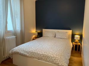 a bedroom with a white bed with two pillows at Elegant Central Vincennes Paris in Vincennes