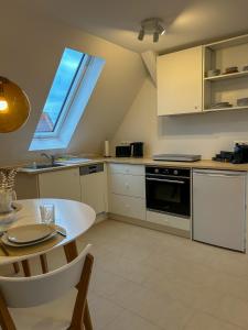 a small kitchen with a table and a window at FeWo AS 5 One Bamberg in Hallstadt