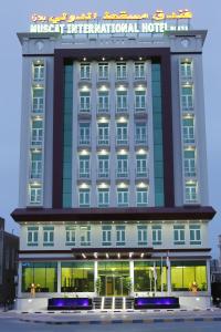 a hotel building with a sign on top of it at Muscat International Hotel Plaza in Salalah