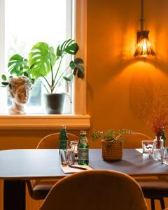 a table with two bottles on it with a window at First Hotel Christian IV in Kristianstad