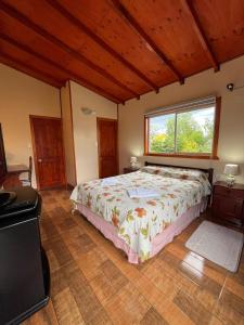 Un dormitorio con una cama grande y una ventana en Hospedaje Brisas de Frutillar en Frutillar