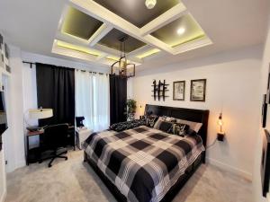 a bedroom with a large bed and a desk in it at Welcome to Happy Place where Cozy Comfort Meets Exquisite Luxury in Edmonton