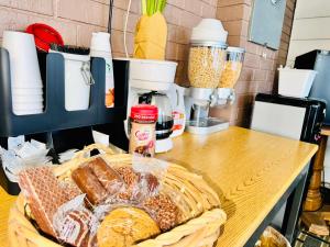 a table with a basket of bread and other ingredients at Holiday Pines Inn and Suites in Jay
