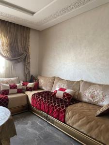 a living room with a couch and a window at Apartment in Agadir (avenue des far ) in Agadir