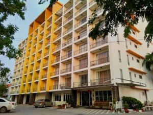 an apartment building with yellow and orange balconies at โรงแรม ศิราภา เรสซิเด้นท์ จำกัด in Chachoengsao